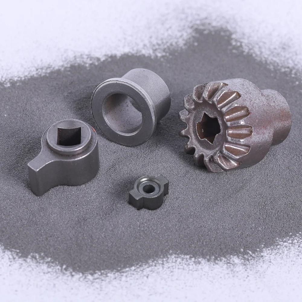 Gear parts sitting in a bed of metal powder.