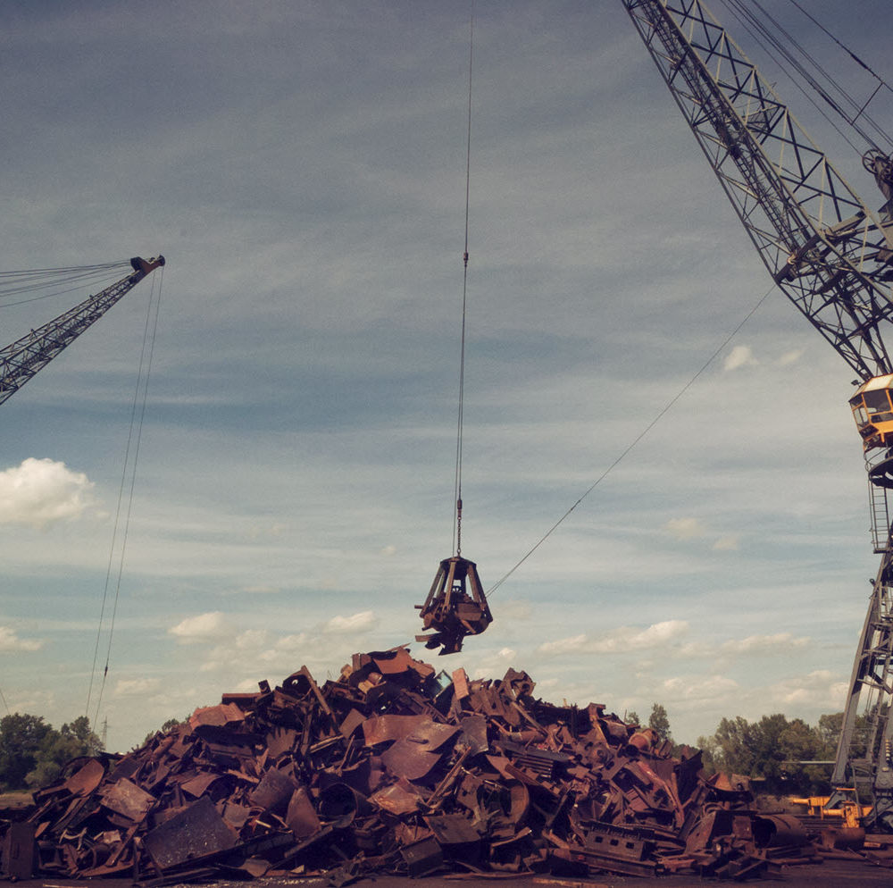 Metal recycling cranes over scrap metal