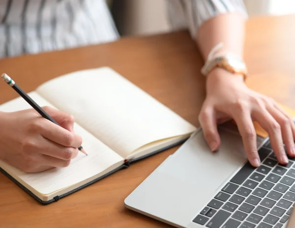 person-writing-at-computer_AdobeStock_263470667_2250x1500