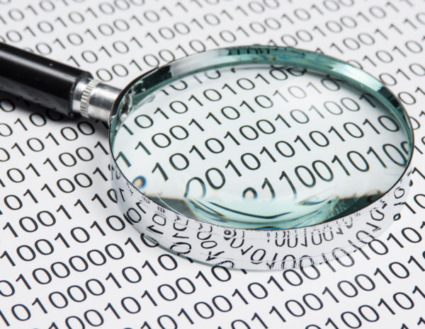 Magnifying glass with binary code - half