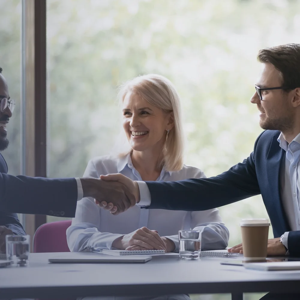 people-shaking-hands-at-business-meeting-AdobeStock_445857788_2000x1125_more-gradient